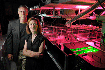 Image: University of Colorado Boulder physics professors and JILA fellows Margaret Murnane, right, and Henry Kapteyn pose next to one of their laser devices (Photo courtesy of Glenn Asakawa/University of Colorado).